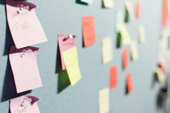 An image of sticky notes pinned to a wall.